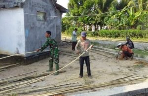Babinsa Serka Tri Wilopo Bersama Warga Gotongroyong Bangun  Pagar Desa